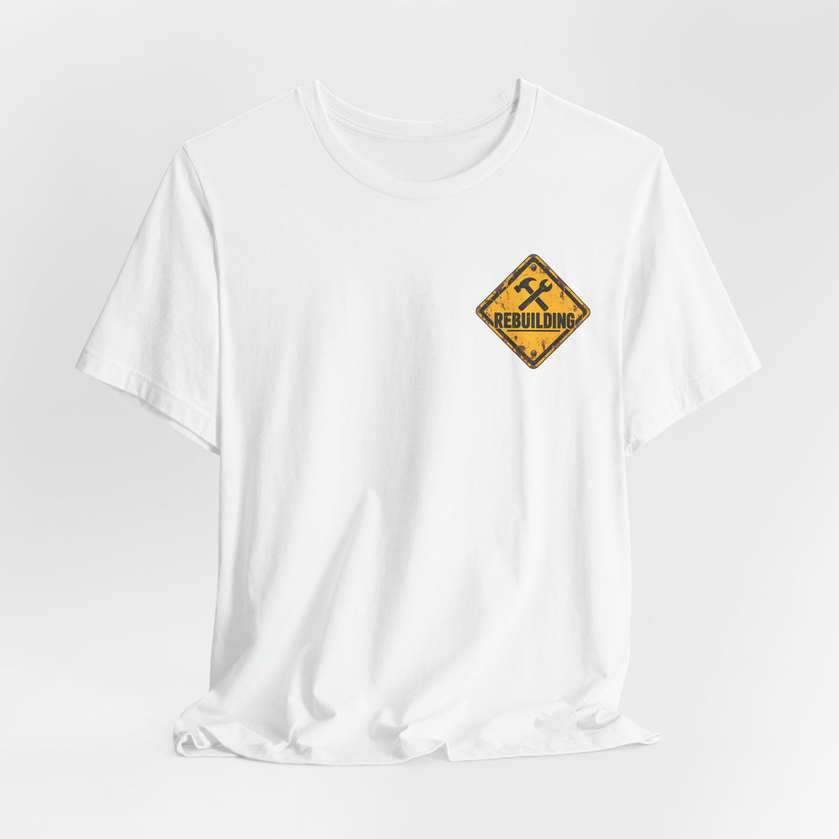 Under Construction — Unisex Tee | I’m Rebuilding — Roots Recovery Housing