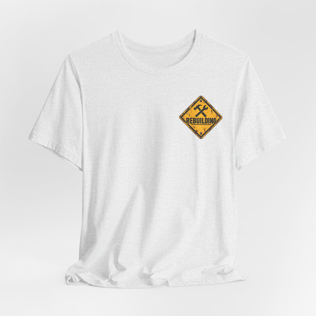 Under Construction — Unisex Tee | I’m Rebuilding — Roots Recovery Housing