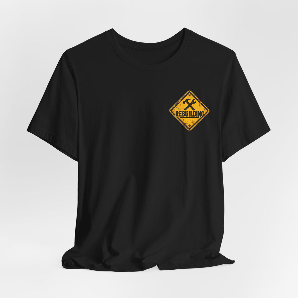 Under Construction — Unisex Tee | I’m Rebuilding — Roots Recovery Housing