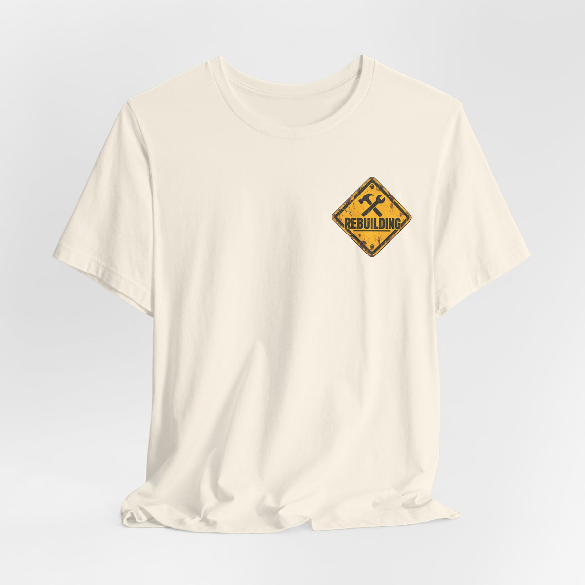 Under Construction — Unisex Tee | I’m Rebuilding — Roots Recovery Housing