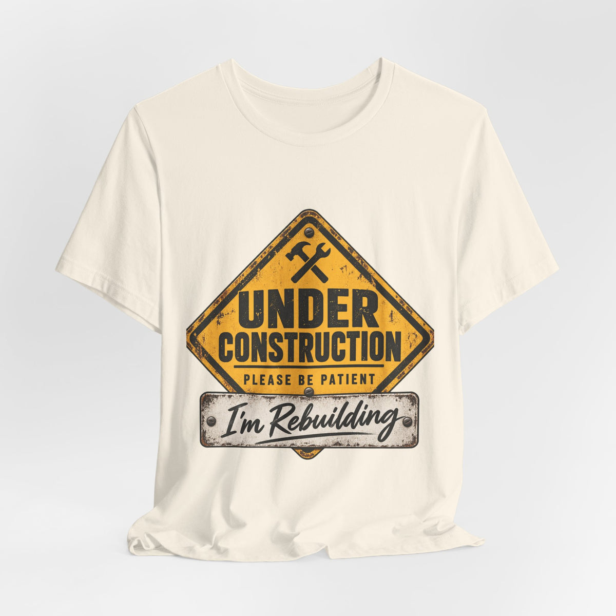 Under Construction — Unisex Tee | I’m Rebuilding — Roots Recovery Housing